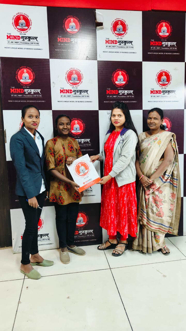 Student and family receiving a Mind Gurukulam programme folder