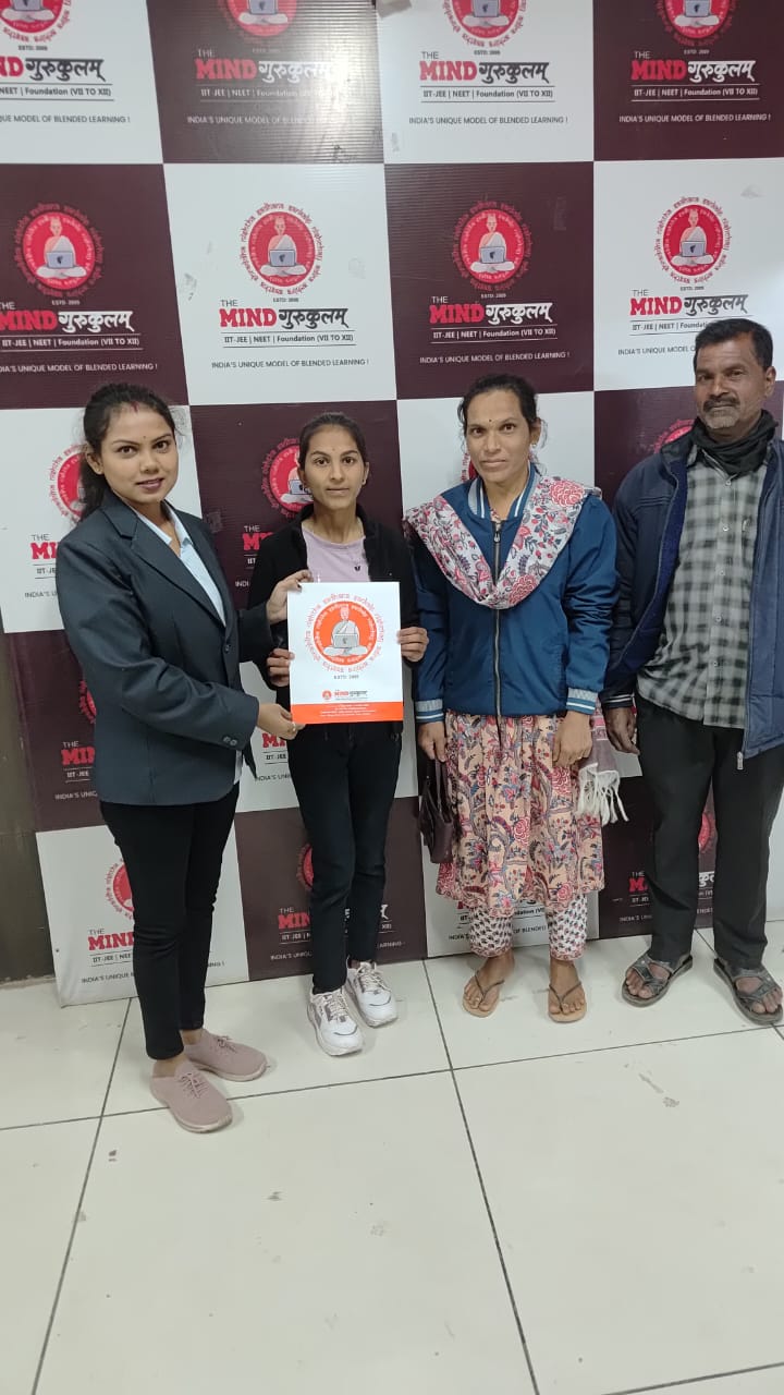 Parents and student receiving programme material from Mind Gurukulam staff